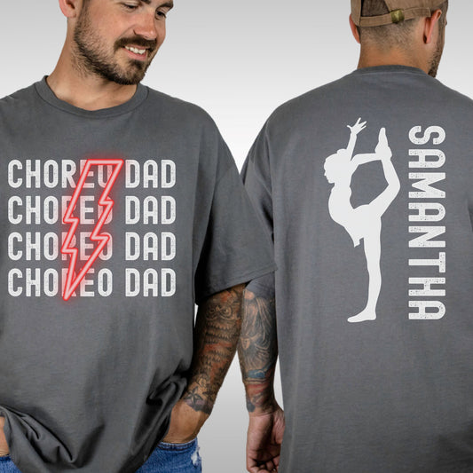 Trendy Comfort Colors Shirt with choreo dad repeated with a red lightning bolt in the middle. On the back of the shirt is a dancer with a customizable name.