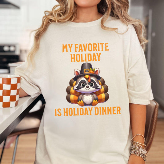 My favorite Holiday is Holiday Dinner with a raccoon dressed as a turkey on a comfort colors shirt